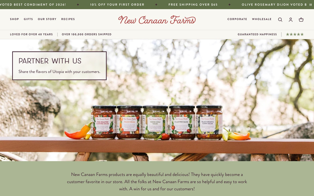 The New Canaan Farms wholesale page: five salsa jars on a wooden rail under the heading Partner With Us, Share the flavors of Utopia with your customers, then a retailer testimonial on sage green.